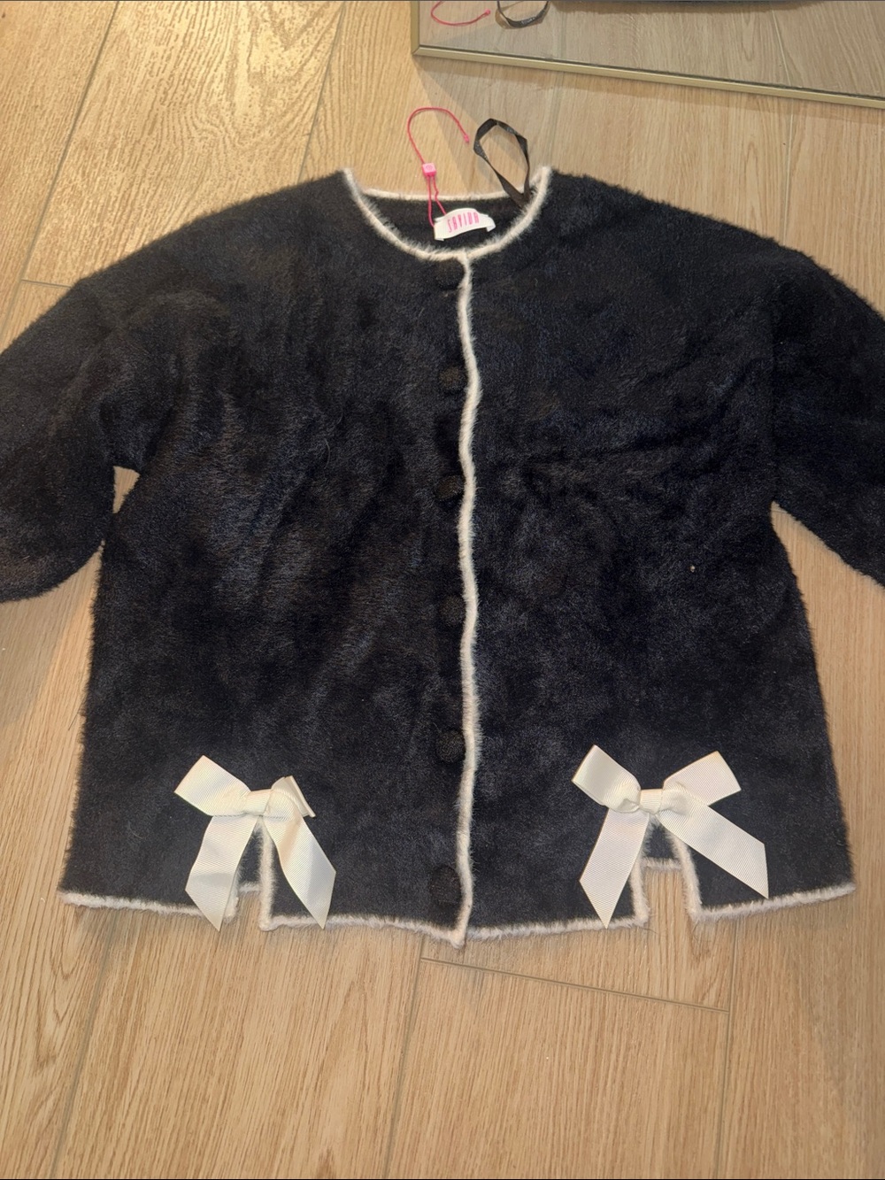 Black Faux Fur Cardigan with Cream Trim and Bow Details